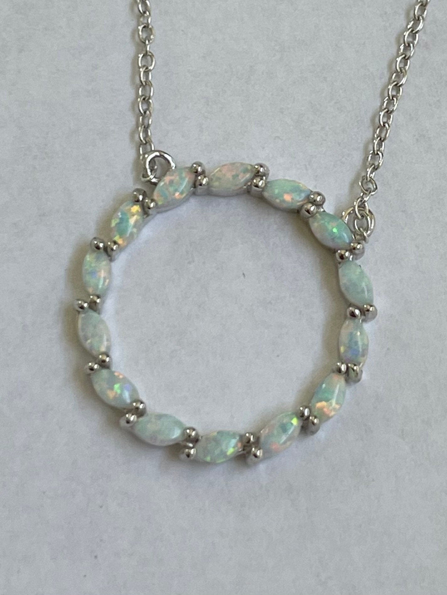 Fire Opal Sterling Silver Circle Pendant Necklace: CZ Accent